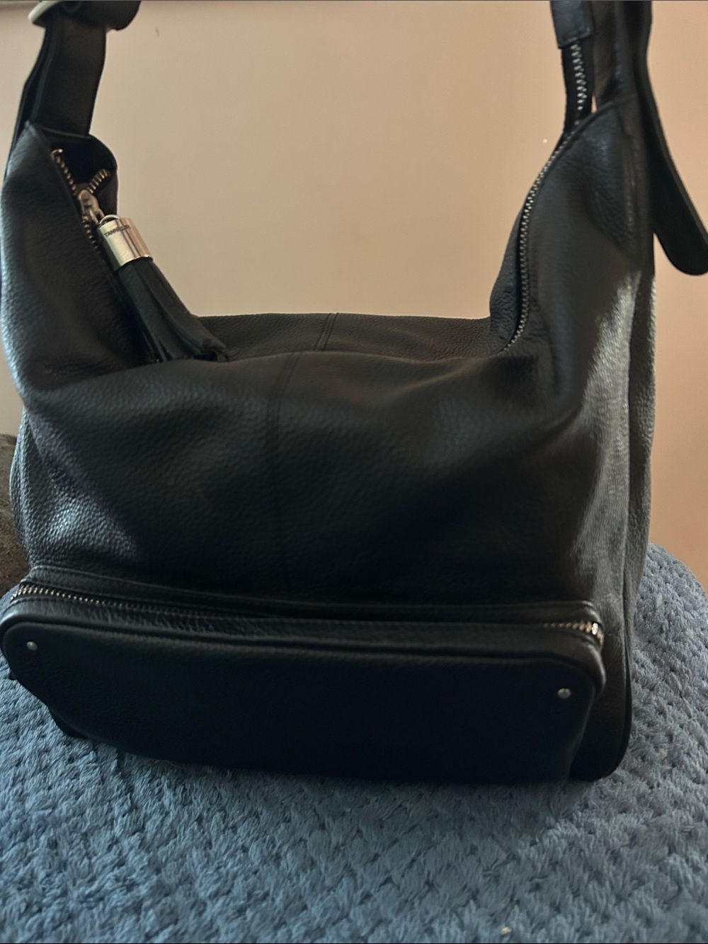 Minimalist Black Leather Hobo Bag with Tassel Accent